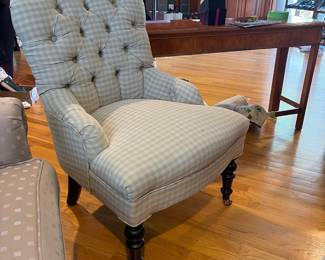 Tufted accent chair on casters
