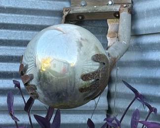 Hands holding the world garden sculpture