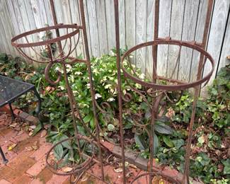 One of two/iron garden trellises (each with four plant holders)