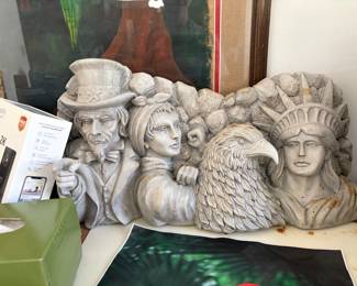decorative stone-style sculpture featuring American patriotic icons including Uncle Sam, Rosie the Riveter, a bald eagle, and the Statue of Liberty