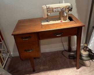 Dress maker, sewing machine in cabinet