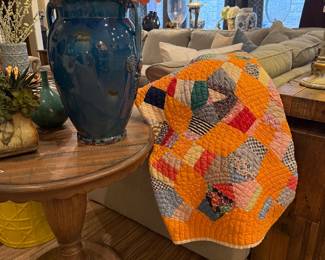 Scalloped accent table, beautiful quilts, 