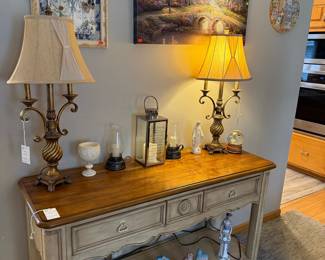 French Country Console Table with Ornate Lamps and Decorative Houses