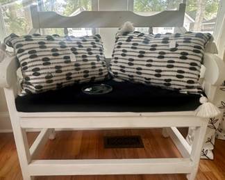 Painted wood bench with pillows