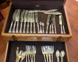 Family history indicates this .800 European silver flatware originated in Germany and was removed from a large private estate or castle during World War II. The pieces are consistent with late 19th–early 20th century continental silver, including monogrammed service ware and silver-handled knives with Solingen blades—typical of upper-class German households of the period.  During and immediately after the war, many estates were abandoned, requisitioned, or dispersed, and household items like silver flatware were commonly taken, traded, or brought home by soldiers and civilians.  While no formal documentation survives, the style, construction, and materials align closely with this history.