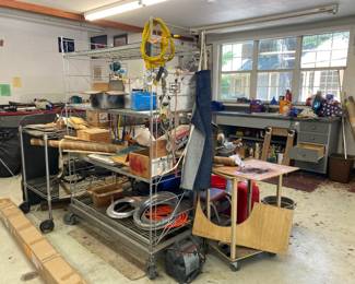 Workshop packed with tools, rolling racks 