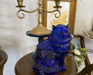 vintage brass candleabra, blue glass cat figurine, wooden plant stand
