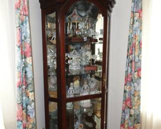 Another curio cabinet filled with Carousel horses and more