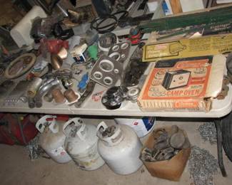 car parts, propane tanks, coleman cook stove and oven