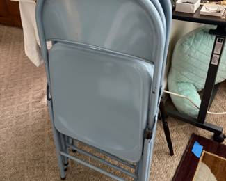 Several sets of metal folding chairs.