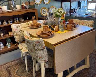 Vintage drop leaf table and 4 chairs. Great condition. 