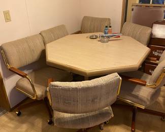 Kitchen table comes with a leaf to extend it. All chairs are on casters.
