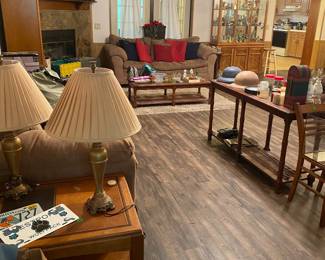 Packed out living room, including a matching loveseat and sofa, matching sofa table/entry table, coffee, table, and side table, and so much more cool stuff