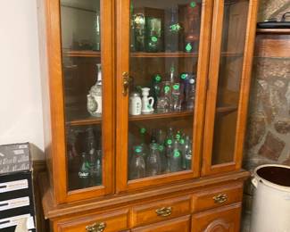 Curio cabinet packed with vintage glass items
