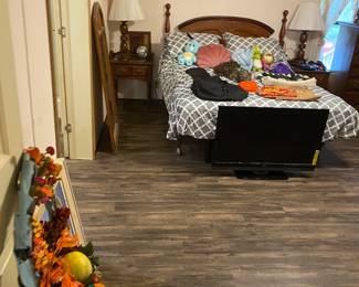 This is an electric platform bed, the headboard has another queen size bed frame attached to it, there are matching side tables, two dressers and so much more in this room