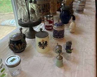 35+/- German beer steins. Antique carrier for oils etc.