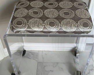 Lot 406: Clear acrylic stool with silver circular-patterned cushion and gold decorative sculptures