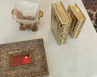 Lot 23: Ornate Framed Artwork, Decorative Glass Bowl, and Gold Book-Shaped Decor