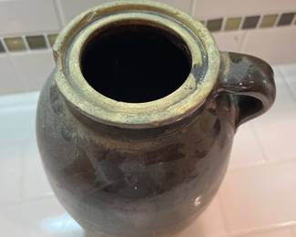 F57 - $40. Antique Stoneware Brown Jug. Measures 6.5" wide x 9.5" tall.