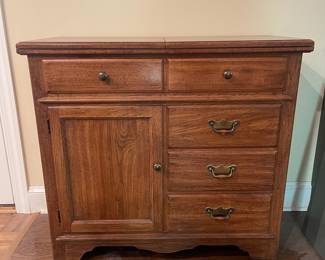 F5 - $150. Thomasville Buffet. Measures 40" wide x 18" deep x 37" tall. When the top flips open it is 80" wide.