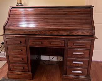 F62 - $125. Jasper Cabinet Roll Top Desk. Measures 55" x 26.75" x 46.5". ON A BASEMENT LEVEL - YOU WILL NEED HELP TO MOVE!