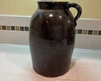 F57 - $40. Antique Stoneware Brown Jug. Measures 6.5" wide x 9.5" tall.