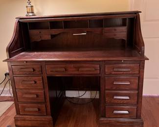 F62 - $125. Jasper Cabinet Roll Top Desk. Measures 55" x 26.75" x 46.5". ON A BASEMENT LEVEL - YOU WILL NEED HELP TO MOVE!