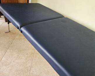 Oversized massage table located at Merritt Island House address is in photos.