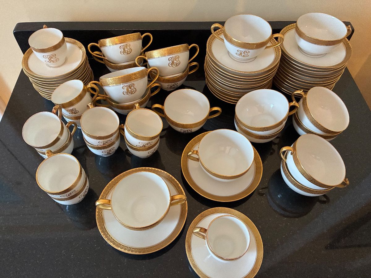 Gold-rimmed Limoges tea cups, espresso cups, bouillon cups and saucers