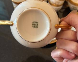 Gold-rimmed Limoges tea cups, espresso cups, bouillon cups and saucers