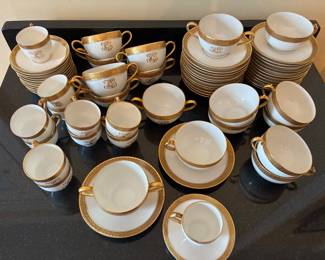 Gold-rimmed Limoges tea cups, espresso cups, bouillon cups and saucers