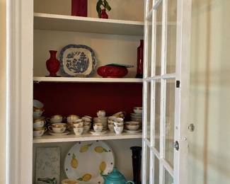 Teal Fiestaware teapot and various pottery, glass, and carved items