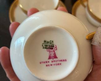 Gold-rimmed Limoges tea cups, espresso cups, and bouillon cups with saucers