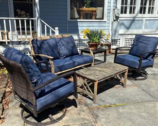 Metal/plastic-wicker outdoor furniture. Chairs (2) and Couch. Chairs swivel. Comes with navy blue cushions as shown. Some minor wear. With covers. Teak table (rectangle) and painted wood side table (square) sold separately.
