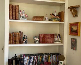 Collection of Staffordshire, old books, DVDs, and an antique cigarette holder