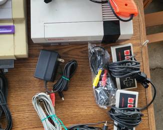 Original Nintendo game console with controllers and gun