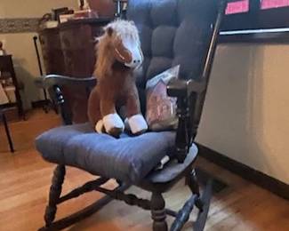 Rocking Chair with cushions, pillow, and horse figure.