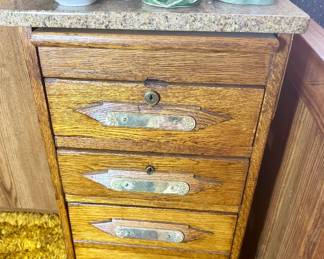 Oak 4-drawer table with granite top.