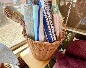Basket full of rag rugs.