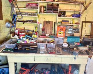 Tool bench full of tools & doodads.