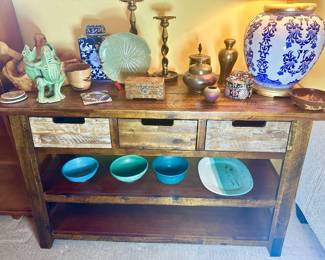 Solid wood console table with 3 drawer storage filled with uniquely beautiful decor.