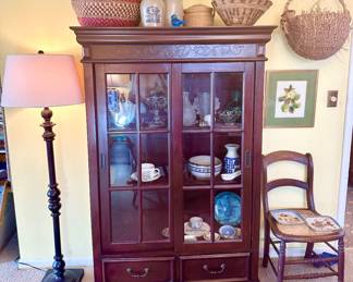Pretty wood cabinet with sliding glass doors.