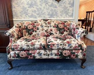 Pair of Matching Loveseats. Curved top back, two cushion seat, cabriole legs with shell design and pad feet. c 1920