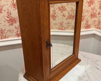 Vintage oak medicine cabinet with original key and mirror.