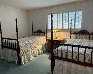 Pair of vintage (circa 1910's) walnut high post, turned spool twin beds.  Original casters, rails and great finish. 