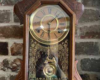 Ingraham Working shelf clock with fancy pendulum, key, and original glass with gilt tracery. Clock and strike are working. c 1880.