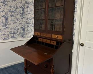 Vintage (c 1880) walnut bookcase drop leaf secretary with paneled sides and 12 pane original glass bookcase top.  Hand cut dovetail drawer construction.  Nice curly maple small drawer fronts and decorative half turned posts on bottom.