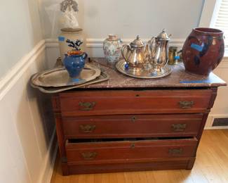 American Gothic chest with marble top; various decorative and Serving items