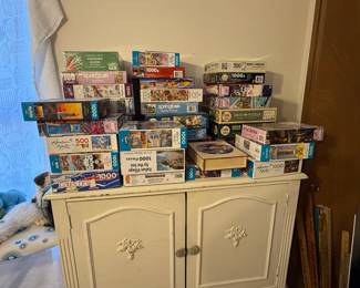 Jigsaw puzzles & antique bureau with 2 doors ( 1 drawer inside doors & open area) & 2 drawers below