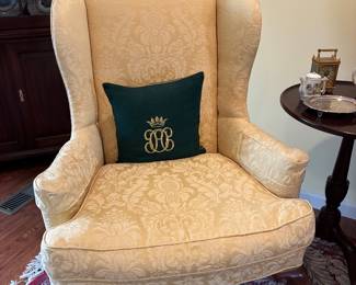 Damask upholstered antique wing chair